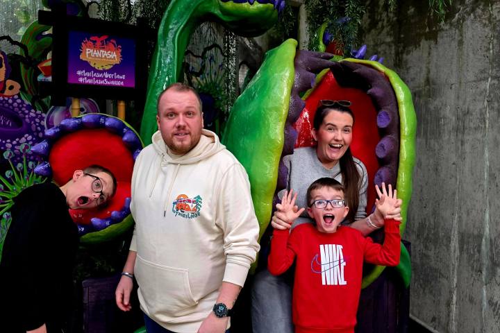 a man and a woman standing in front of a statue