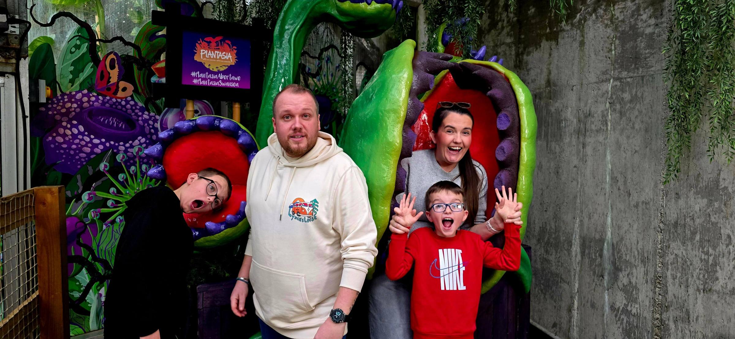 a man and a woman standing in front of a statue