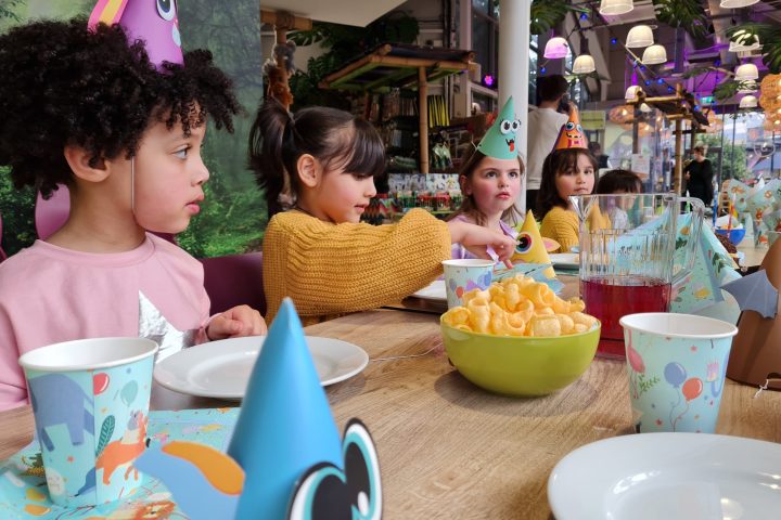 Skylar Burke et al. sitting at a table with a cup of coffee