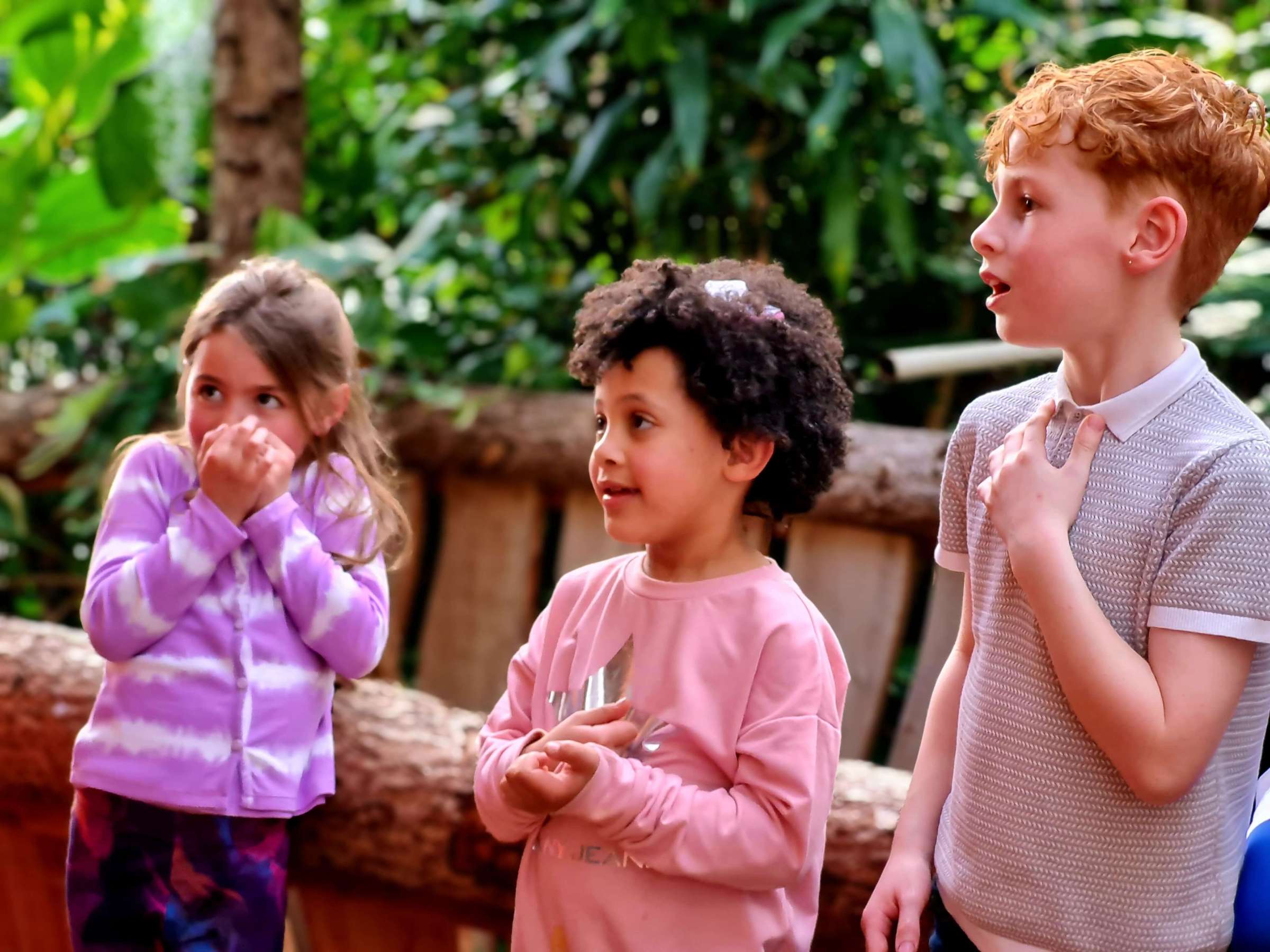 a group of young children with excited expressions on their faces