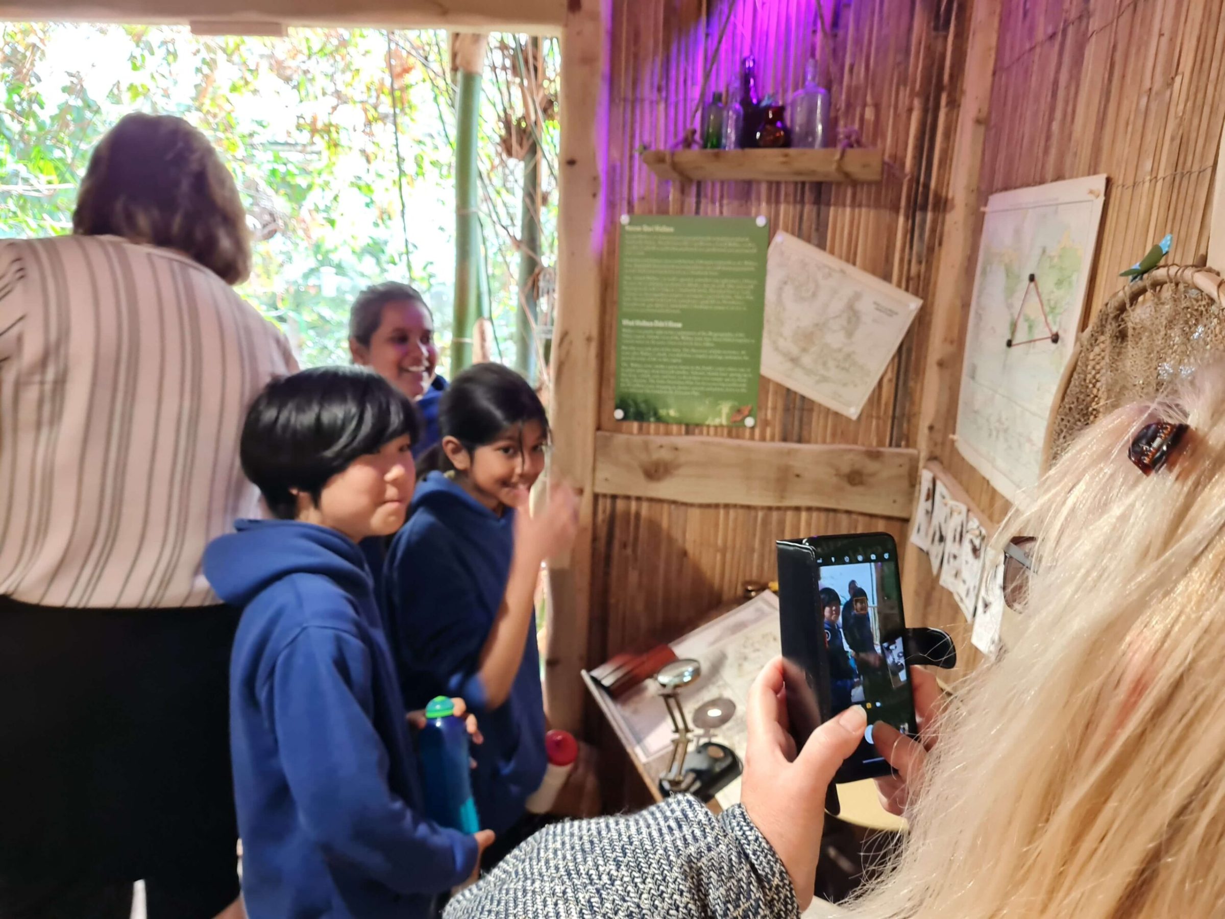 a group of people in a room taking a photo