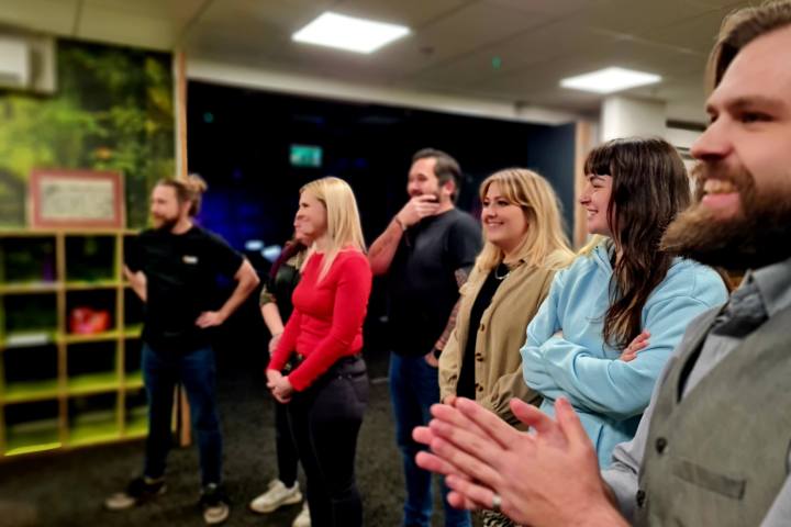 A group of people standing in a line looking in the same direction