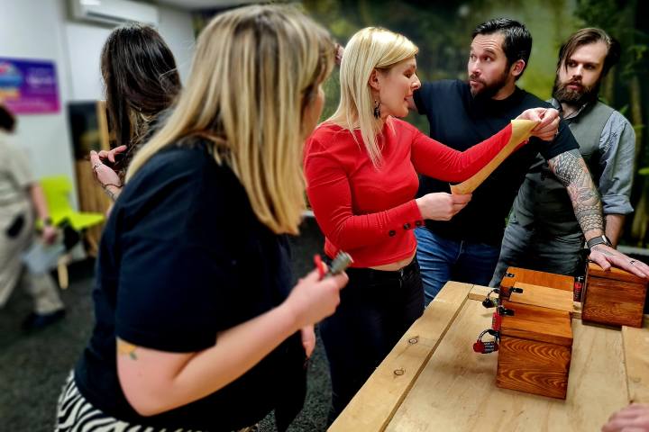 A group of people looking at a piece of paper